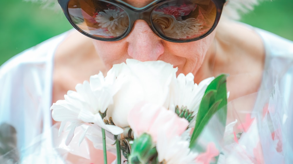 Acceptance in Action: Woman Pausing to Smell the Flowers