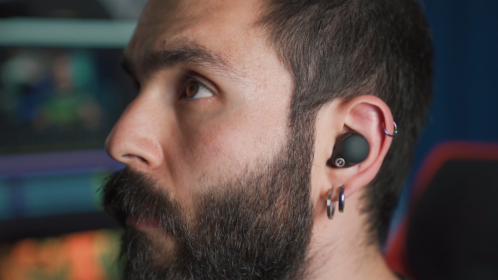 Active Listening: Young Bearded Man Engaged with Wireless Earphones