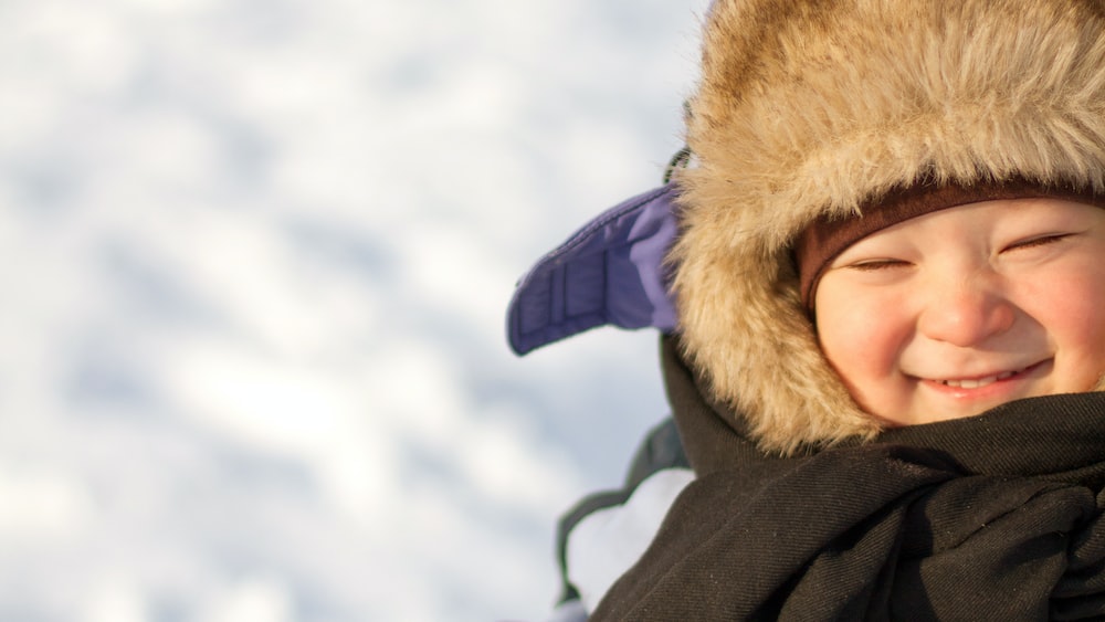 Conquering Winter Challenges: Boy Delighting in Snow