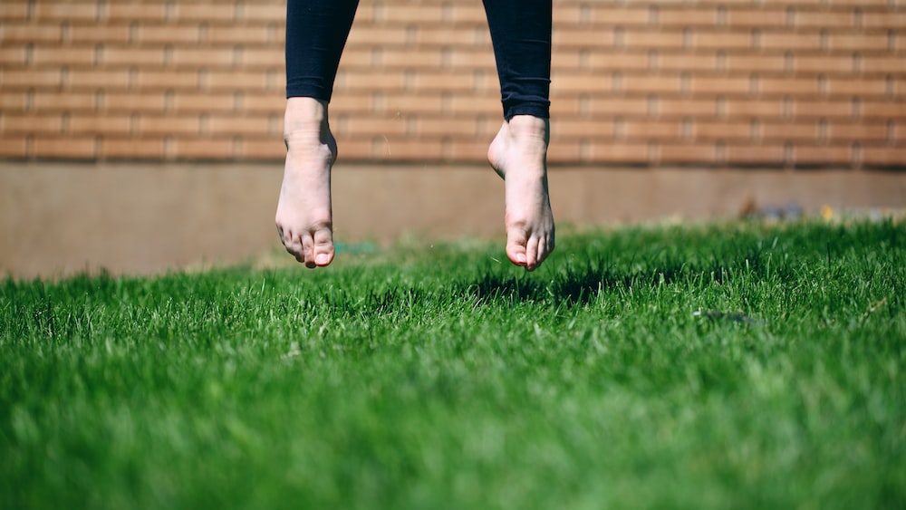 Embracing a Growth Mindset: Person Jumping on Green Grass