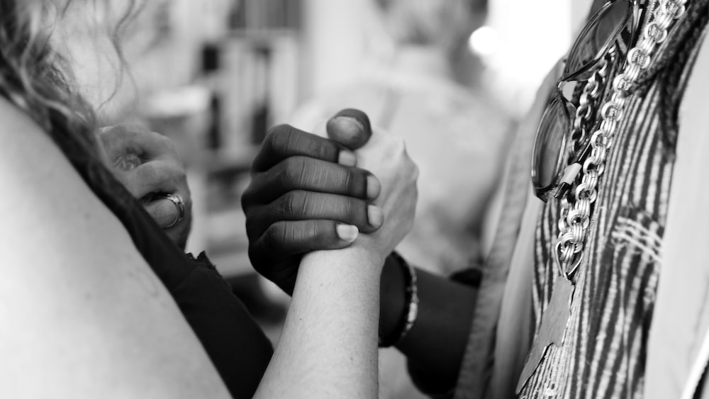 Empathy in Unity Grayscale Image of People Holding Hands