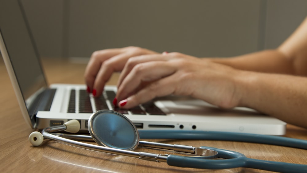 Enhancing Healthcare Accountability through Technology: Stethoscope and Laptop in Action