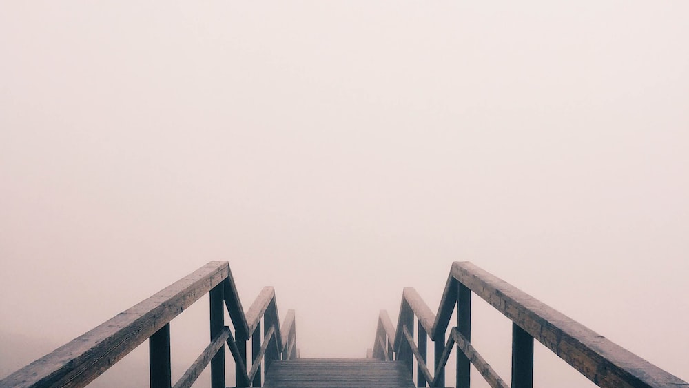 Fearful Descent: A Black Stairway Covered in Fog