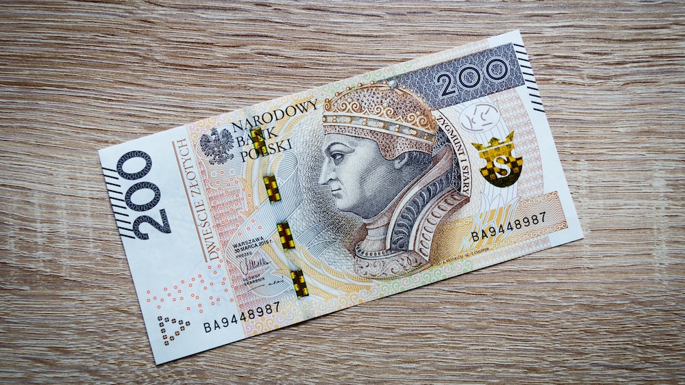 Financial Assistance: Polish Zloty Banknote on Wooden Table