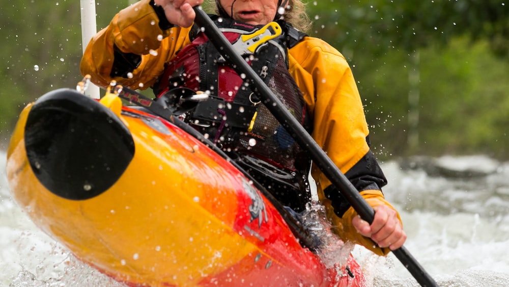 Focused kayaker navigating rapids