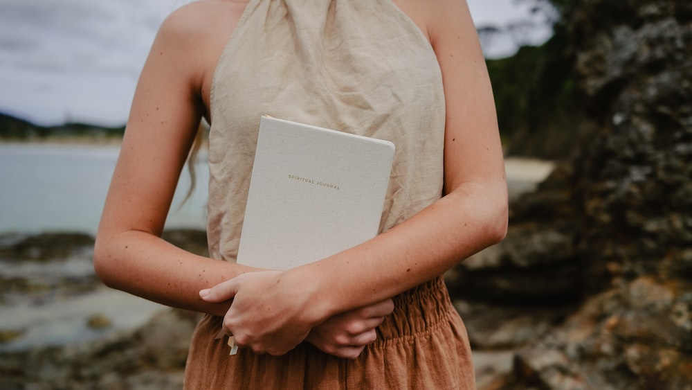 Gratitude Journaling: Woman Holding Spiritual Journal