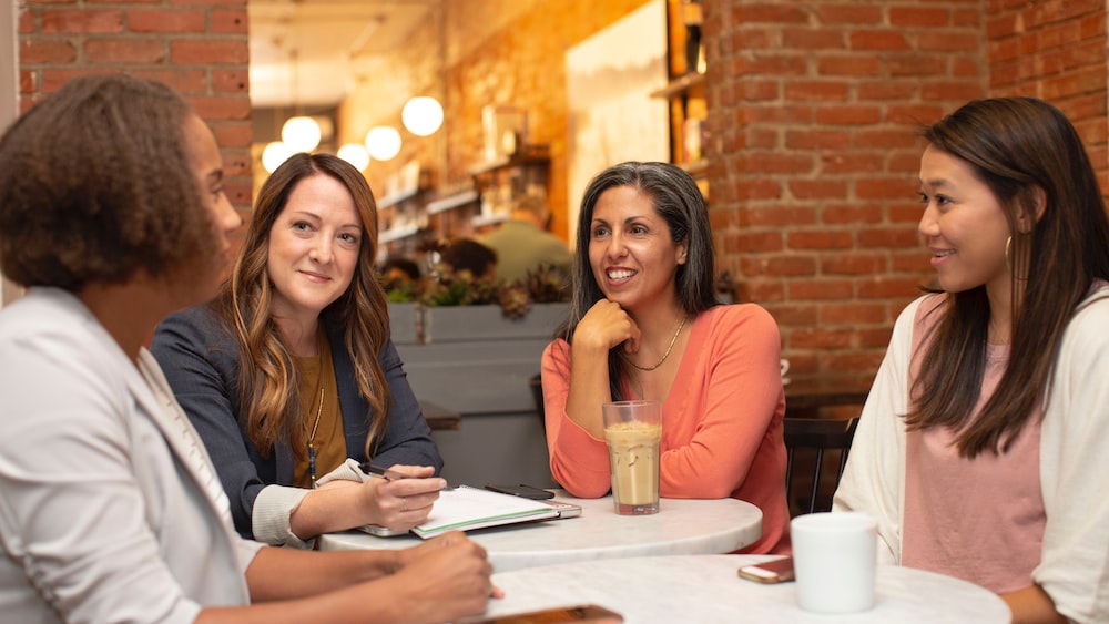 Group of Women Having a Business Meeting in a Cafe