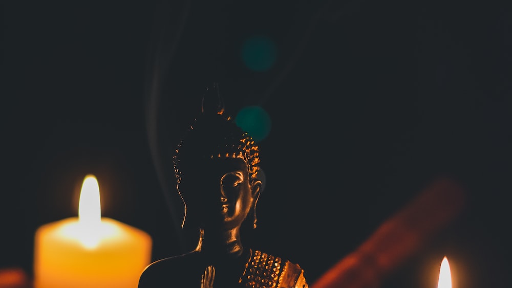 Guided Meditation with Sitting Buddha and Pillar Candles.