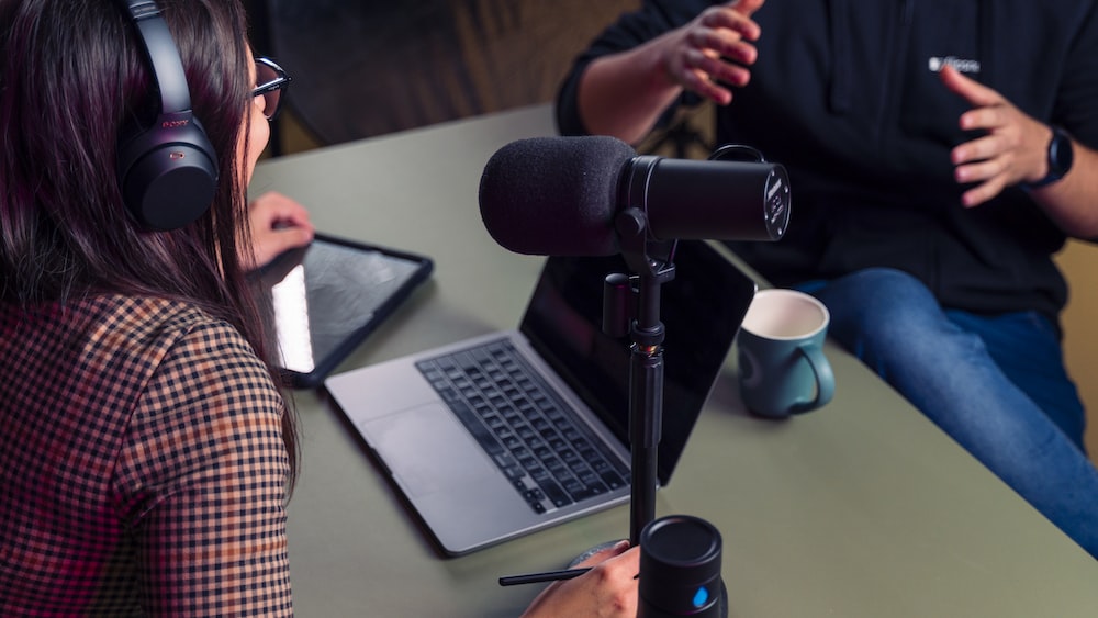 Mindful Conversation: Podcast Host and Guest Discussing with Headphones On