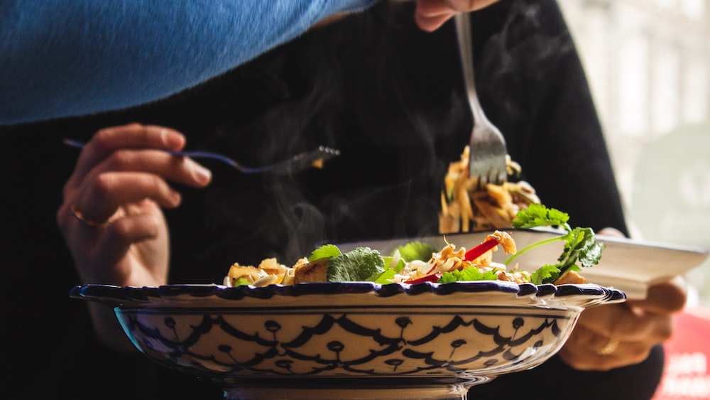 Mindful Eating: Person Holding Fork Picking on Cooked Food