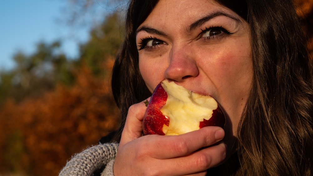 Mindful Eating: The Expressions of a Woman Enjoying an Apple