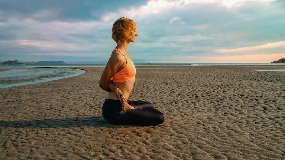 Mindful Lotus Pose: Yogini Meditating on Tropical Beach