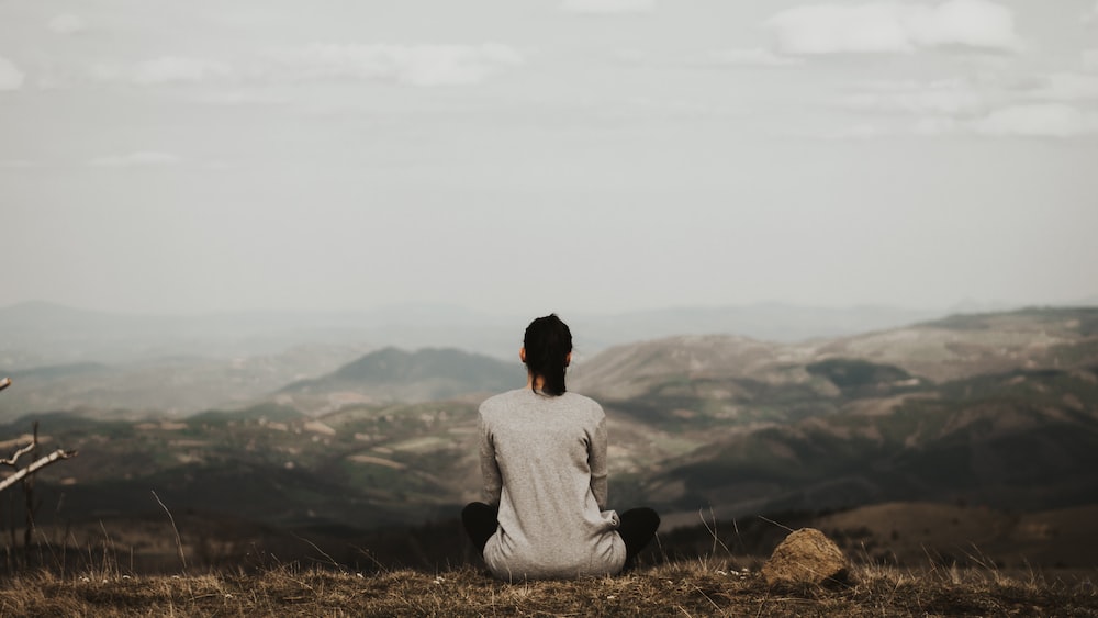 Mindful Mountain Meditation: Woman Practicing Mindfulness Overlooking Mountains