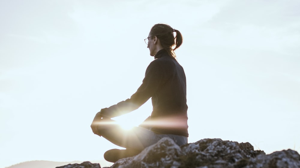 Mindful Nature Connection: Person Meditating on Rock Formation