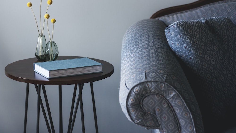 Ownership and Accountability: Sofa Side Table with Blue Book