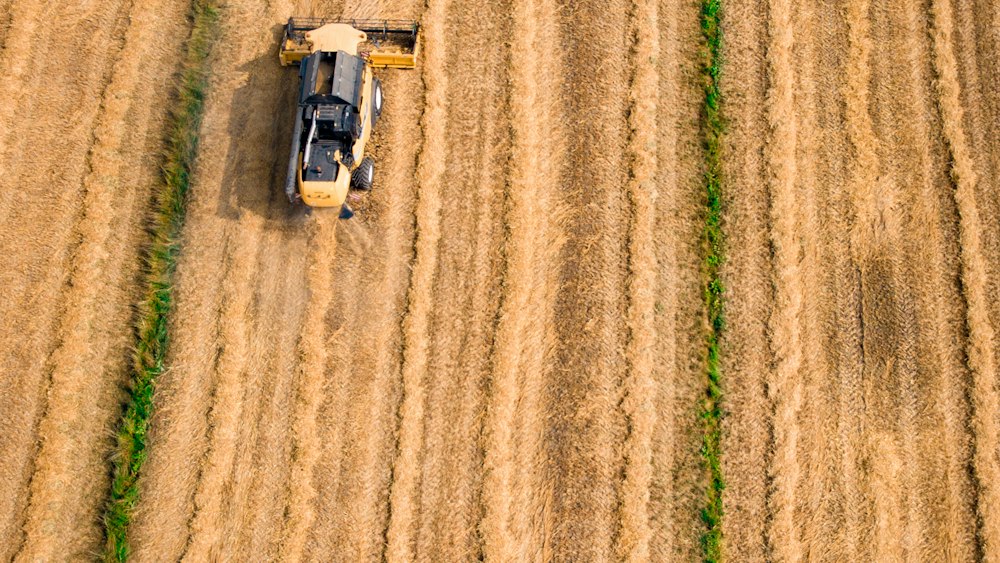 Progress in Workplace Negotiation: Aerial View of Cultivator on Brown Field