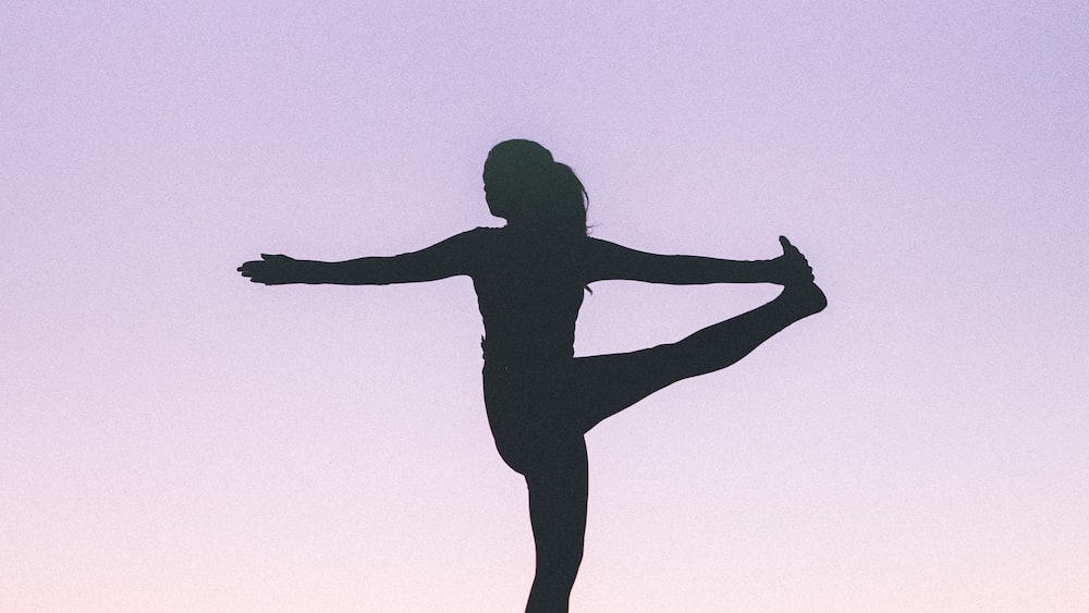 Promoting Wellness Through Yoga: A Silhouette of a Woman in Practice
