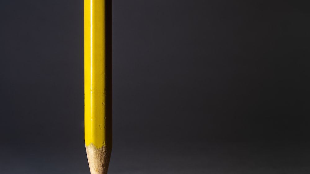 Sharpening Your Problem-Solving Skills: A Yellow Pencil on Black Background.