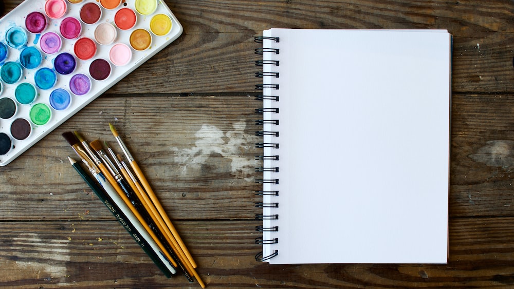 Tools for Mindful Creation: Paint Brushes, Drawing Book, and Watercolor Palette
