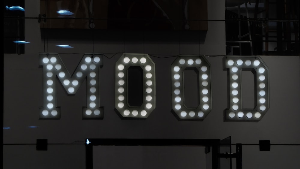 Visual Representation of Emotional Intelligence: The Word 'Mood' Illuminated by Lightbulbs