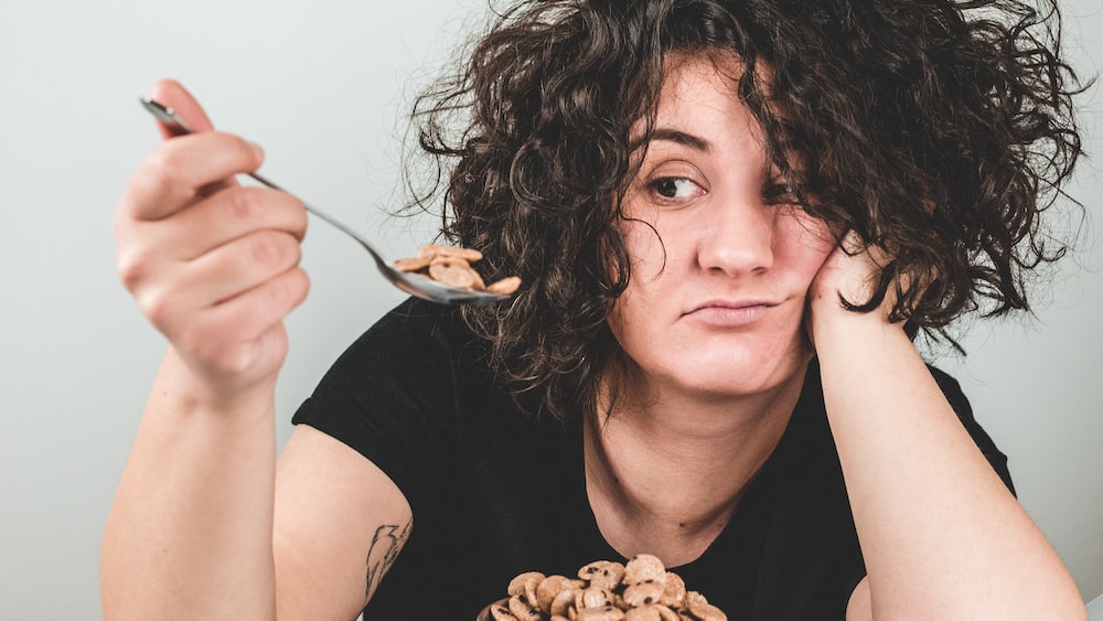 Woman Practicing Mindful Eating with Cereals